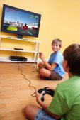 Two kids playing racing video game together
