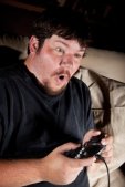 Young man intensely playing video game