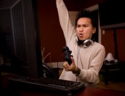 Young man playing PC video game